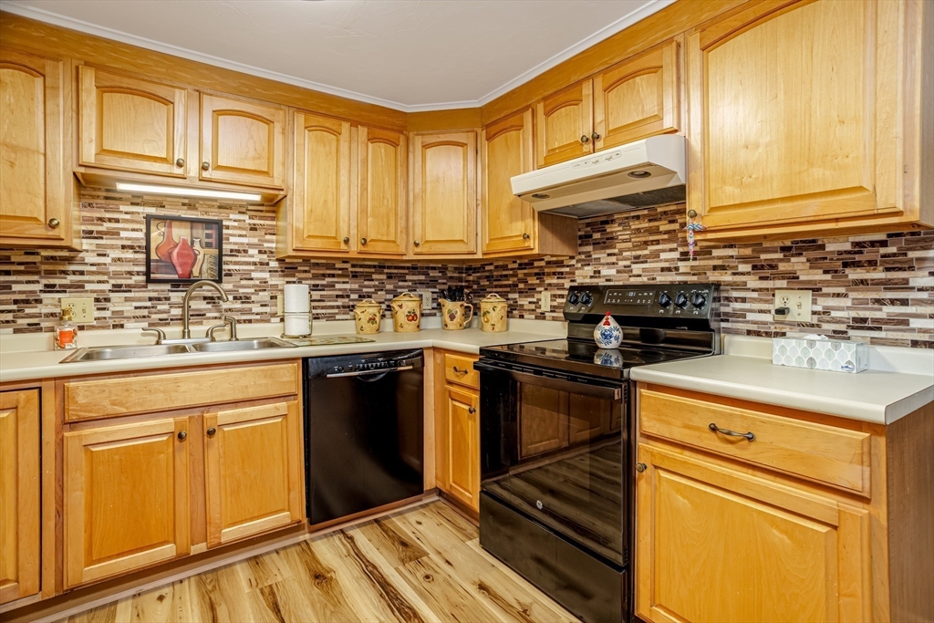 113 Parker Road, Unit 1 Lancaster, MA 01523 - Photo 5 of 30 a kitchen with stainless steel appliances granite countertop a sink stove and cabinets