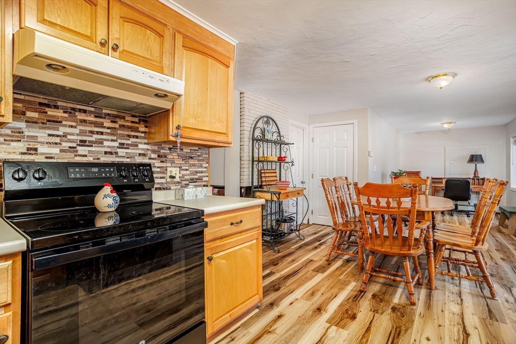 113 Parker Road, Unit 1 Lancaster, MA 01523 - Photo 7 of 30 a view of a dining room with furniture and wooden floor