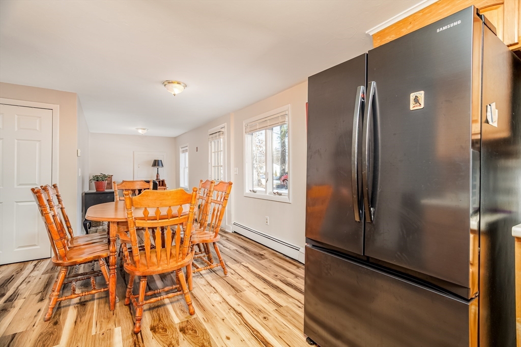 113 Parker Road, Unit 1 Lancaster, MA 01523 - Photo 8 of 30 a dining room with furniture and wooden floor
