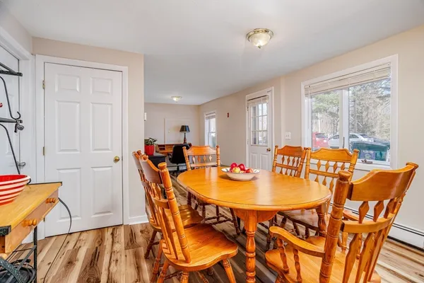 a view of a dining room with furniture and wooden floor