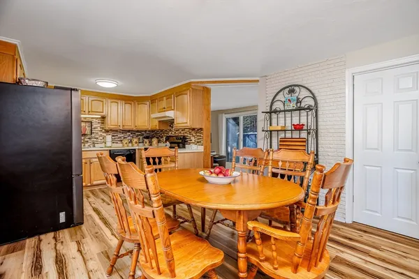 a view of a dining room with furniture and a kitchen