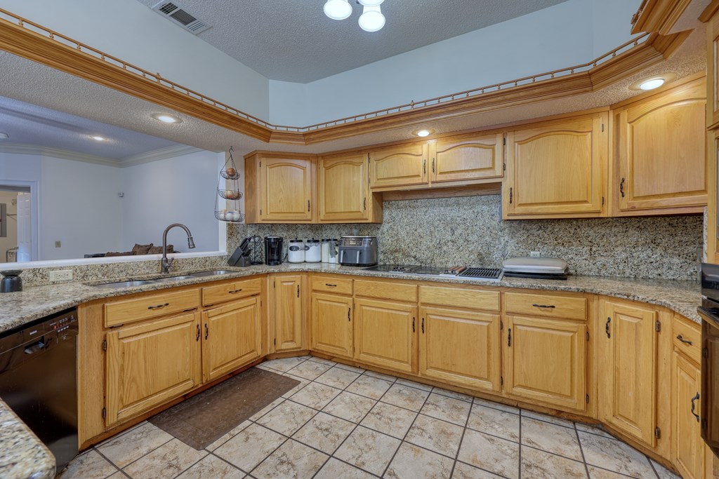 5135 Midland Trace Midland, GA 31820 - Photo 13 of 66 a kitchen with granite countertop cabinets stainless steel appliances a sink and a counter top space