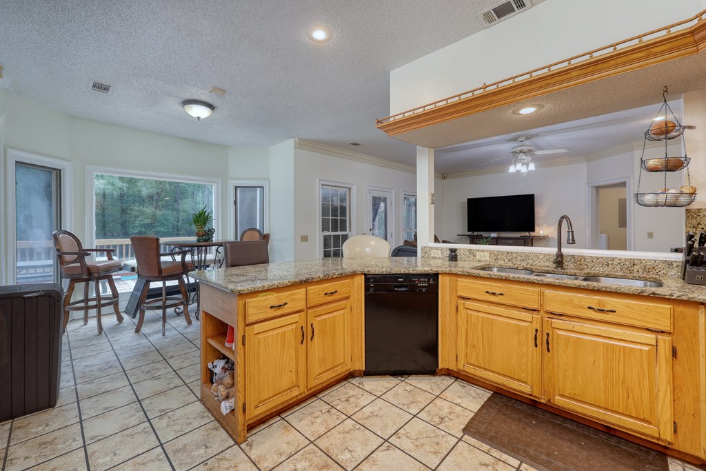 5135 Midland Trace Midland, GA 31820 - Photo 16 of 66 a large kitchen with kitchen island a sink counter space and chairs