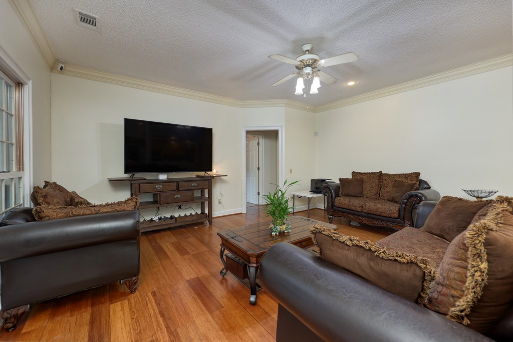 5135 Midland Trace Midland, GA 31820 - Photo 20 of 66 a living room with furniture and a flat screen tv