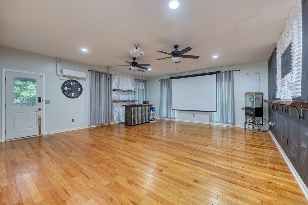 5135 Midland Trace Midland, GA 31820 - Photo 21 of 66 a view of an empty room with wooden floor and a kitchen