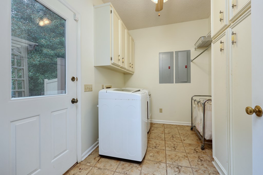 5135 Midland Trace Midland, GA 31820 - Photo 23 of 66 a utility room with cabinets washer and dryer