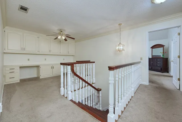 a spacious bedroom with a bed and a flat screen tv