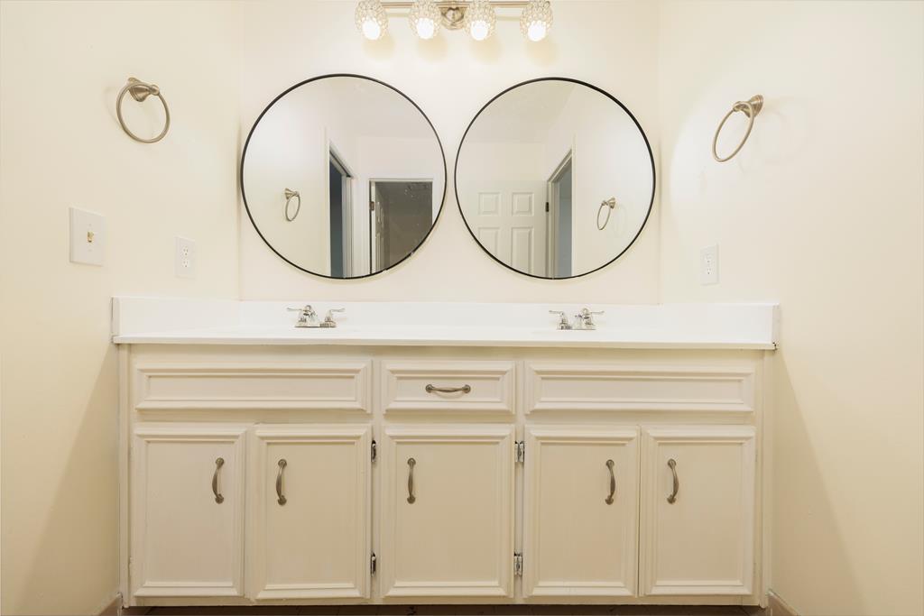 5135 Midland Trace Midland, GA 31820 - Photo 31 of 66 a bathroom with a sink a mirror and a mirror