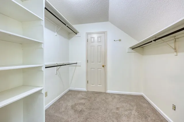 a bathroom with a granite countertop sink a toilet and a mirror
