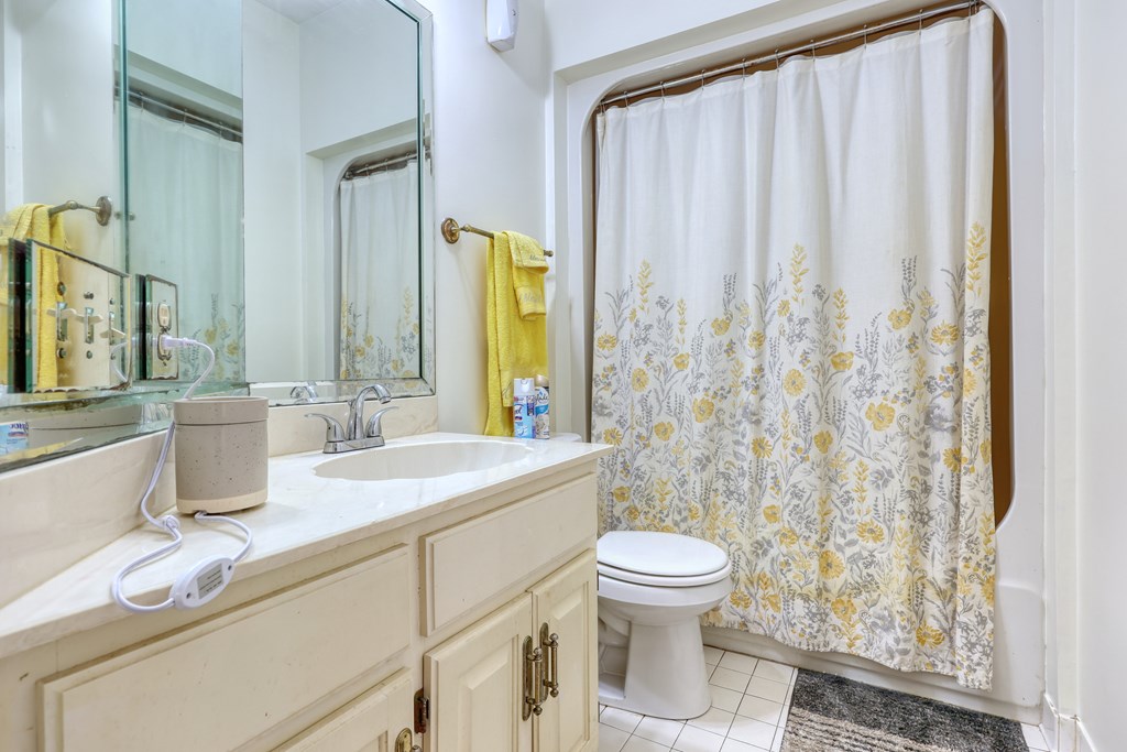 5135 Midland Trace Midland, GA 31820 - Photo 37 of 66 a bathroom with a granite countertop sink a toilet and a mirror