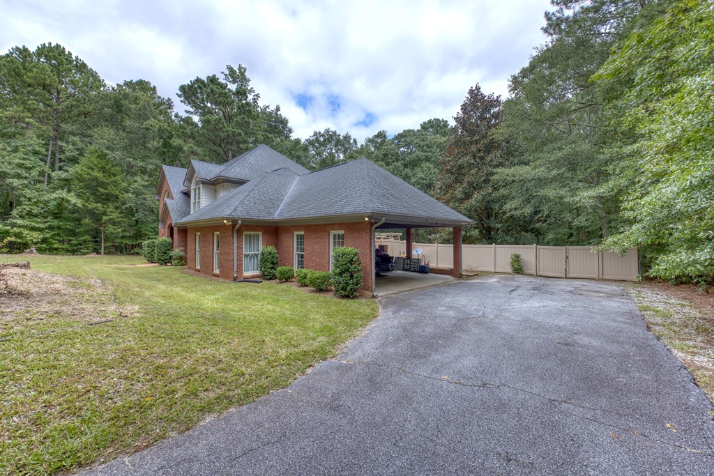 5135 Midland Trace Midland, GA 31820 - Photo 4 of 66 a view of a big house with a big yard and large trees