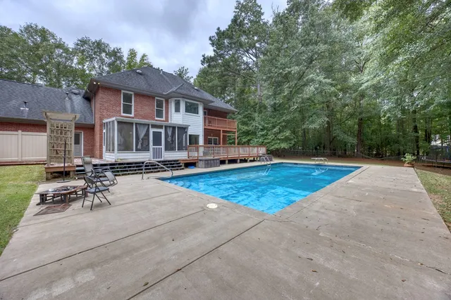 a backyard of a house with table and chairs