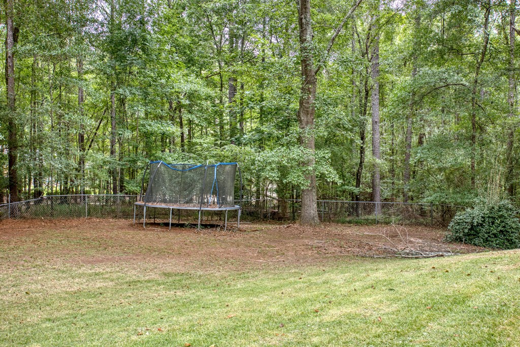 5135 Midland Trace Midland, GA 31820 - Photo 51 of 66 a backyard of a house with table and chairs