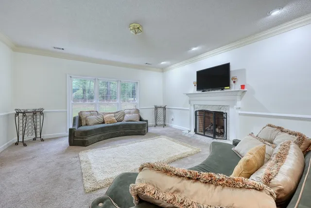 a dining room with furniture a chandelier and window