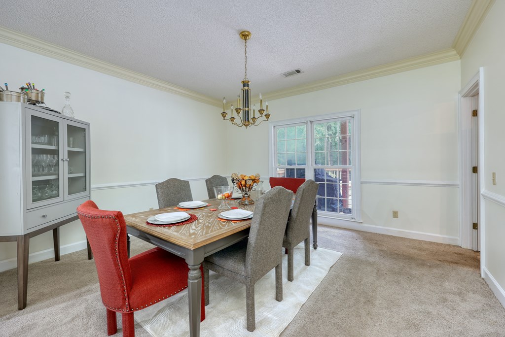 5135 Midland Trace Midland, GA 31820 - Photo 10 of 66 a dining room with furniture a chandelier and window