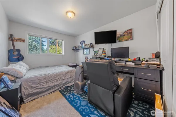 a bedroom with a bed and a flat screen tv