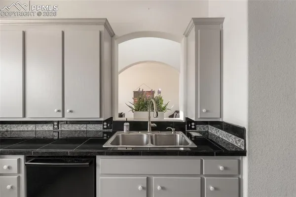 a kitchen with a sink and cabinets