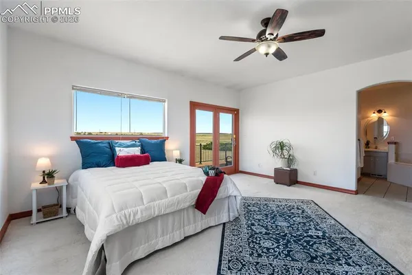 a bedroom with a bed and ceiling fan