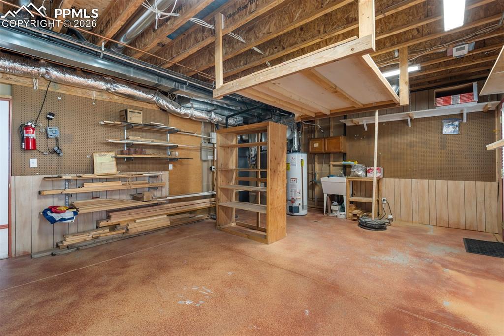 11424 McKissick Road Peyton, CO 80831 - Photo 26 of 33 Large work/storage area, another exterior door to lower deck