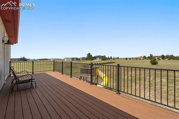 a view of a balcony with wooden floor space