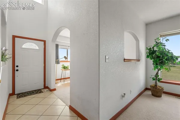 a view of an entryway with wooden floor