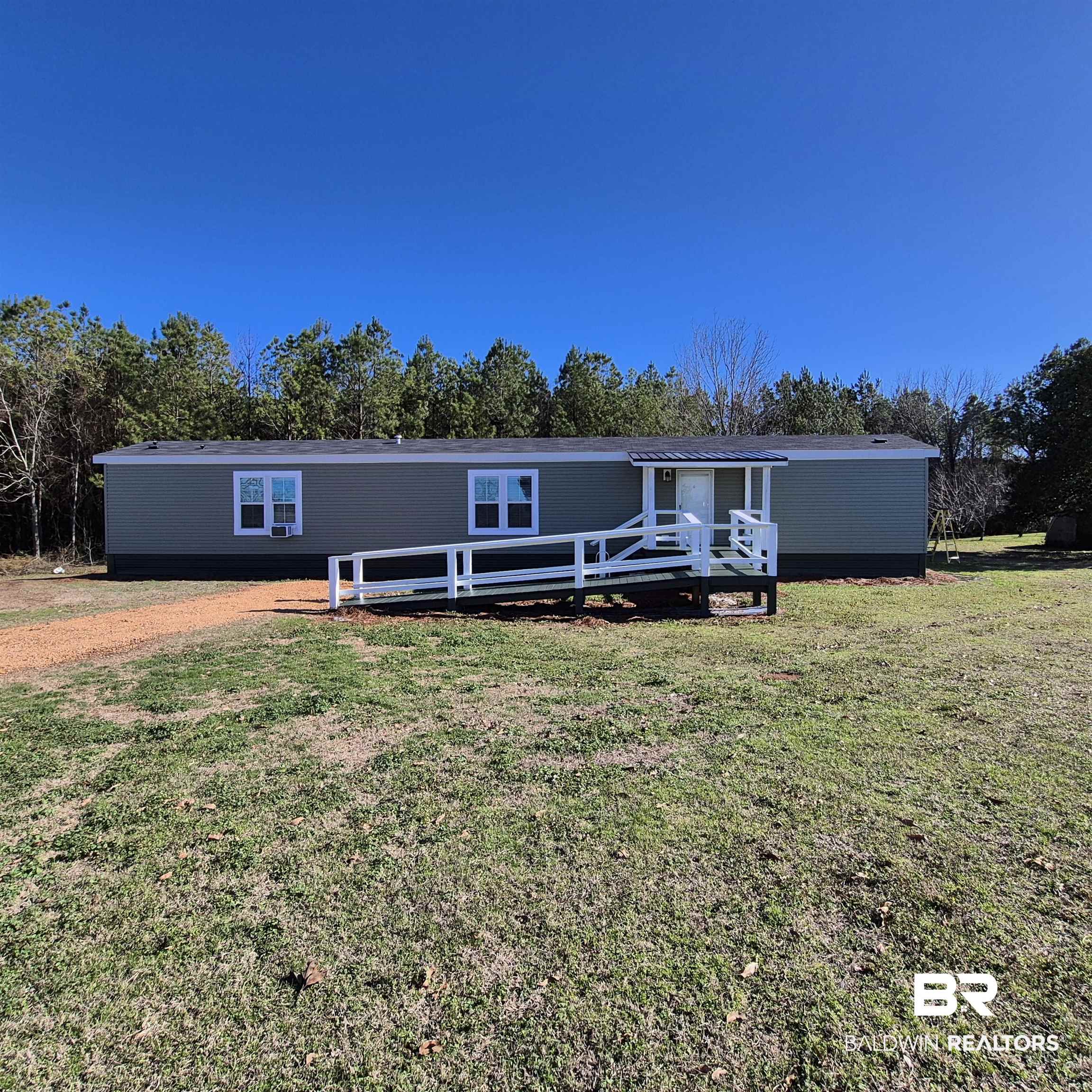 8867 Old Stage Road Repton, AL 36475 - Photo 30 of 37 Manufactured / mobile home with a front lawn and a deck