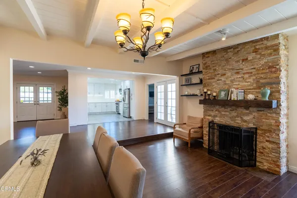 a living room with fireplace furniture and a wooden floor