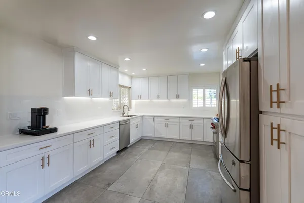 a kitchen with a sink stainless steel appliances and cabinets