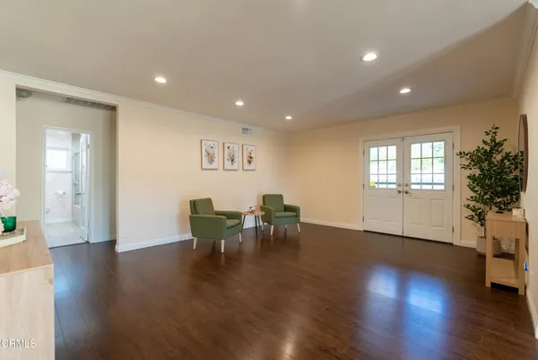 a view of a work space with furniture and wooden floor