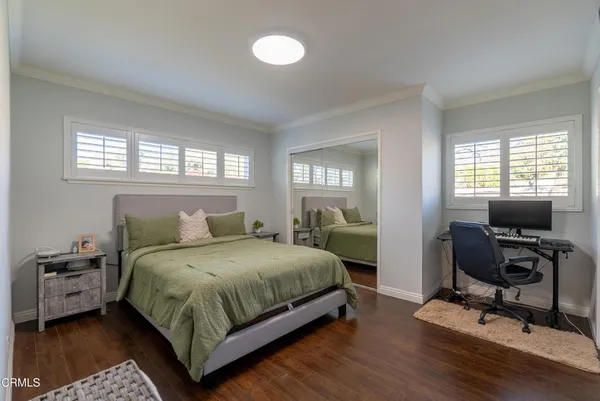 a bedroom with a bed a table and chair