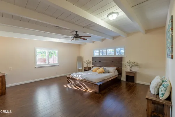 a spacious bedroom with a bed and a table in it