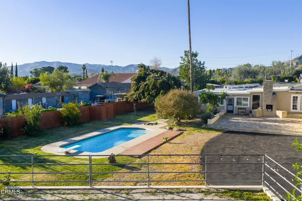 a swimming pool with outdoor seating and yard