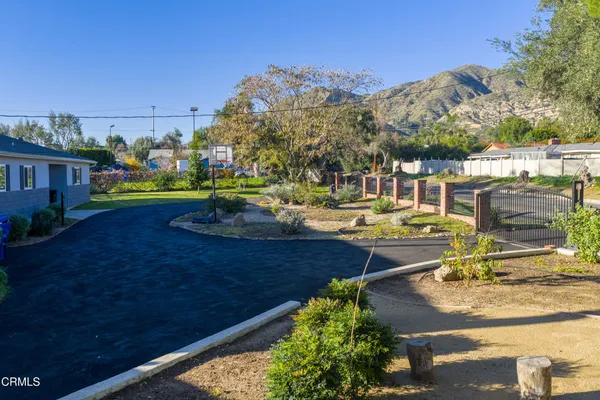 a view of a swimming pool with a patio and a yard