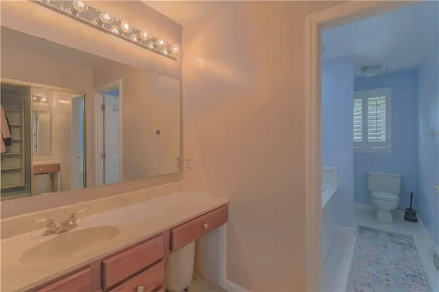 a white bath tub sitting next to a toilet