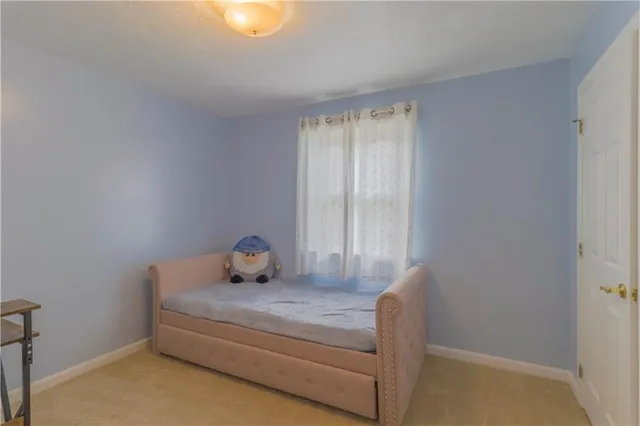 a bedroom with two beds and painted walls