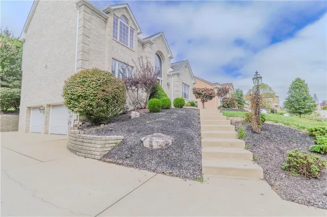 a kitchen with stainless steel appliances a stove refrigerator sink and microwave
