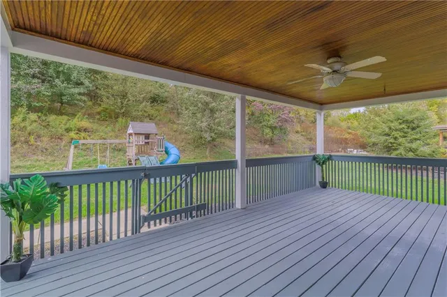 a view of a porch with wooden floor and fence