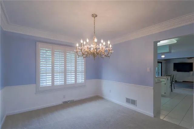 a living room with chandelier and a chandelier