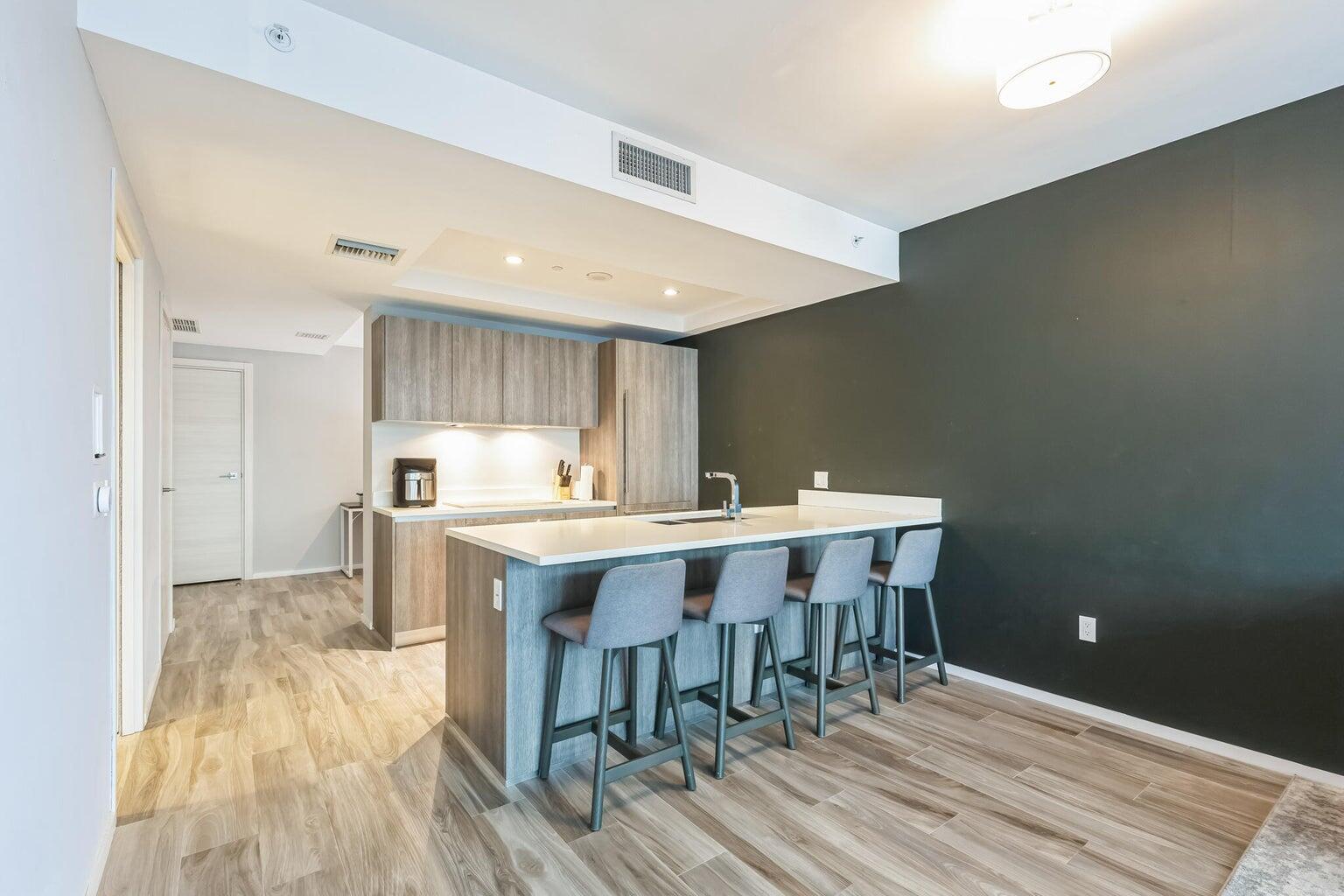 801 South Miami Avenue, Unit 3607 Miami, FL 33131 - Photo 11 of 38 a kitchen with a sink cabinets and wooden floor