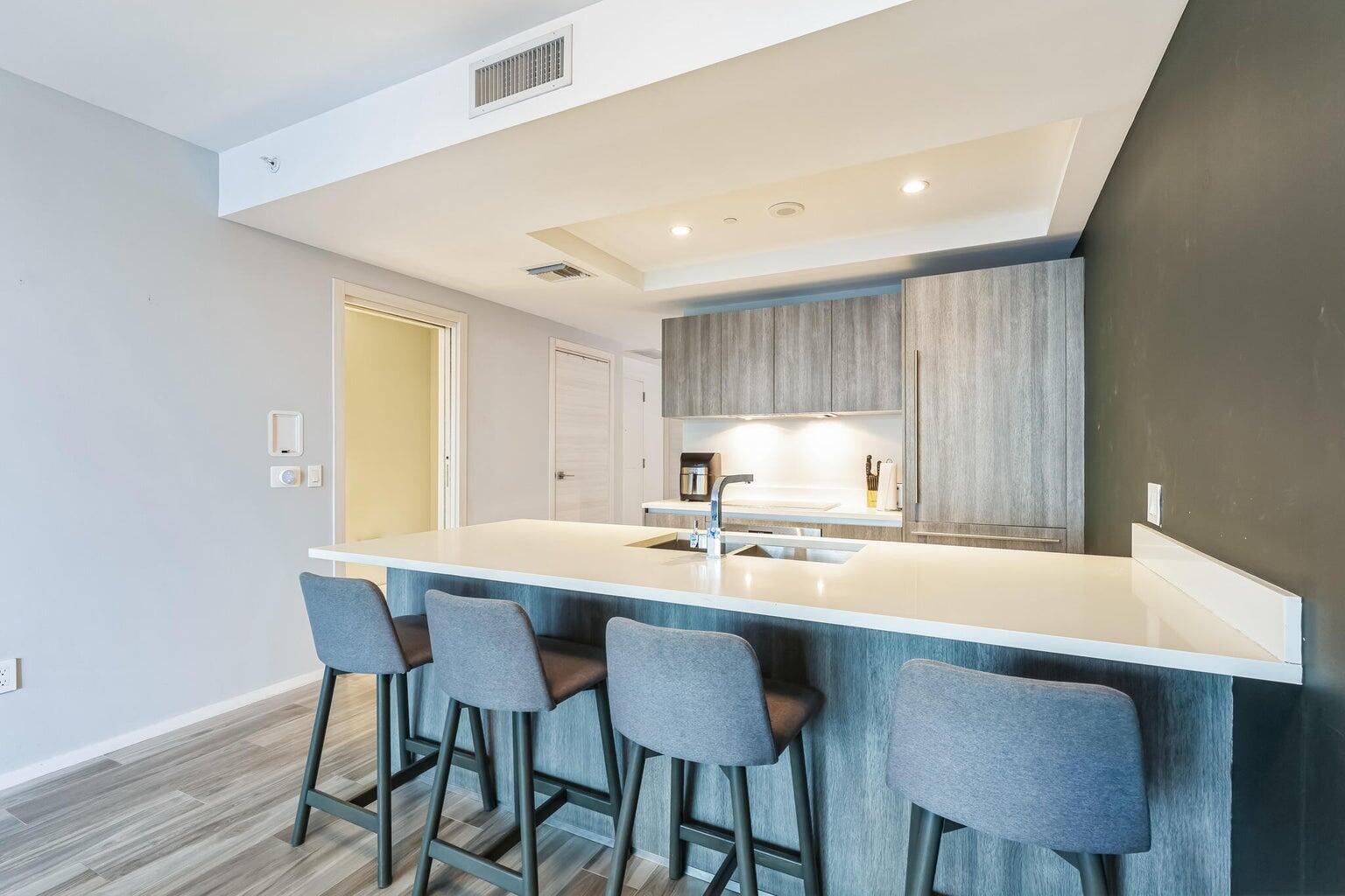 801 South Miami Avenue, Unit 3607 Miami, FL 33131 - Photo 12 of 38 a kitchen with a dining table chairs and a refrigerator