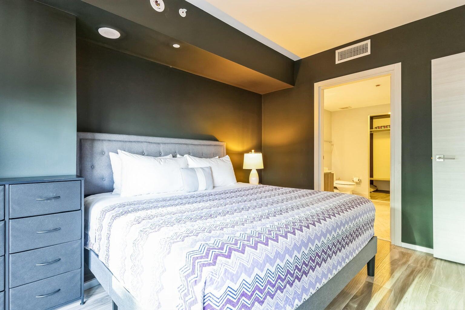 801 South Miami Avenue, Unit 3607 Miami, FL 33131 - Photo 26 of 38 a bedroom with a bed and wooden floor