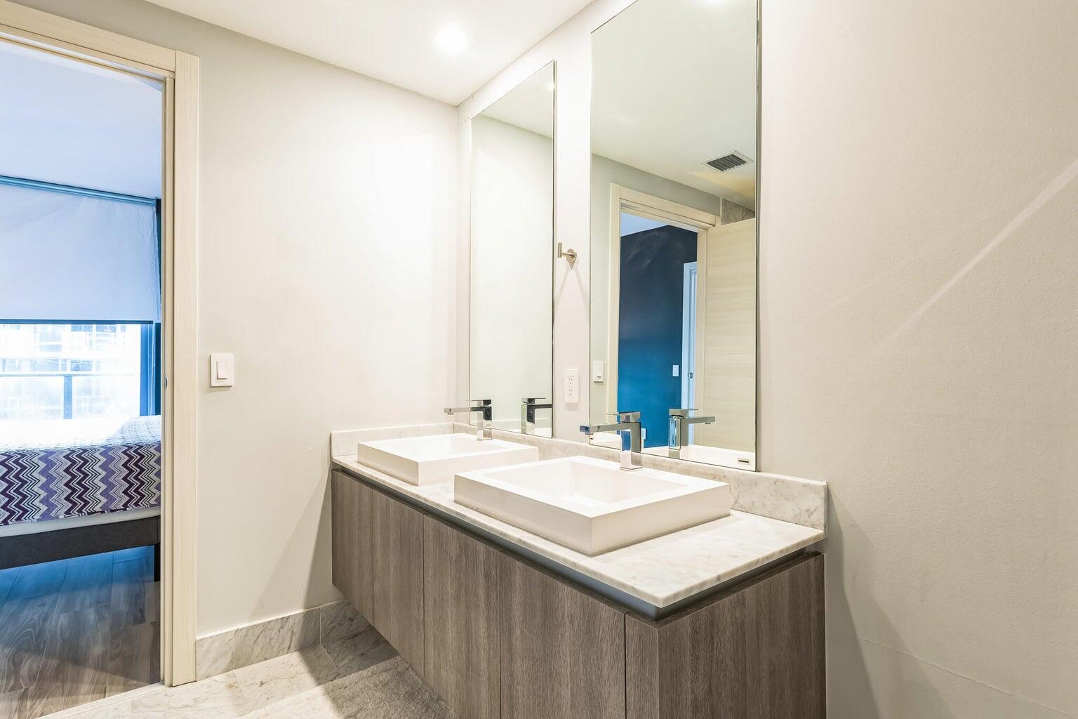 801 South Miami Avenue, Unit 3607 Miami, FL 33131 - Photo 27 of 38 a bathroom with a sink and a mirror