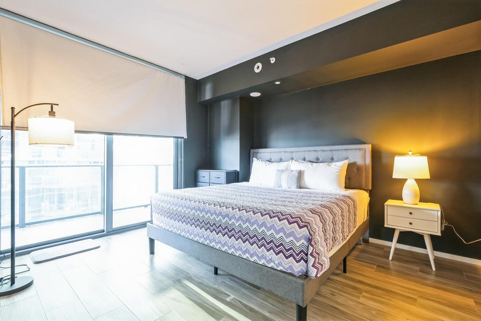 801 South Miami Avenue, Unit 3607 Miami, FL 33131 - Photo 30 of 38 a bedroom with a bed and wooden floor