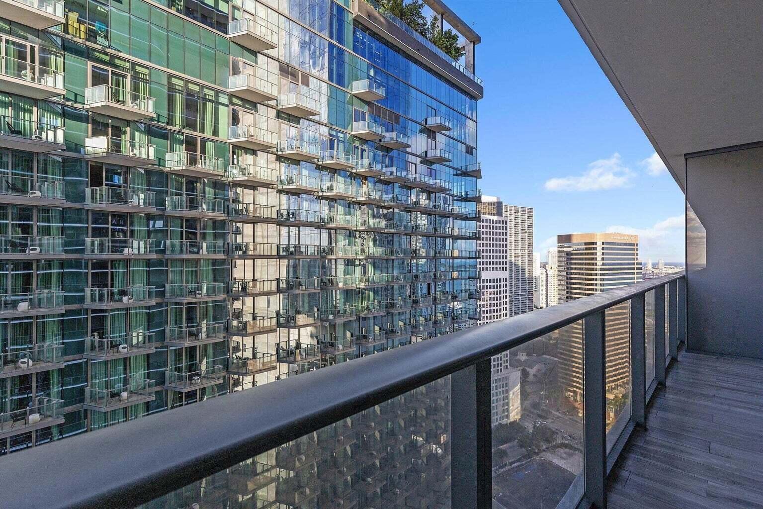 801 South Miami Avenue, Unit 3607 Miami, FL 33131 - Photo 3 of 38 a view of balcony with a floor to ceiling window and wooden floor