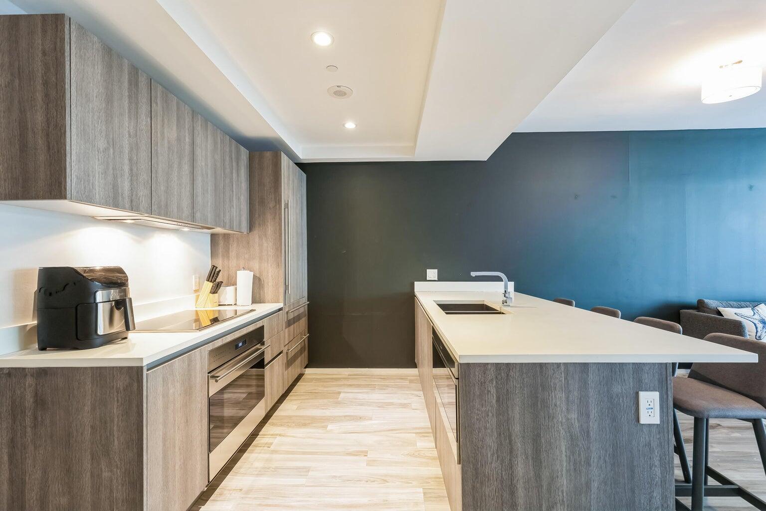 801 South Miami Avenue, Unit 3607 Miami, FL 33131 - Photo 10 of 38 a kitchen that has a sink and a wooden floor