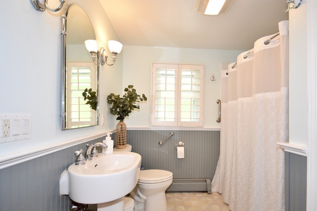 29 Tecumseh Road Bourne, MA 02562 - Photo 12 of 28 a bathroom with a toilet sink and mirror