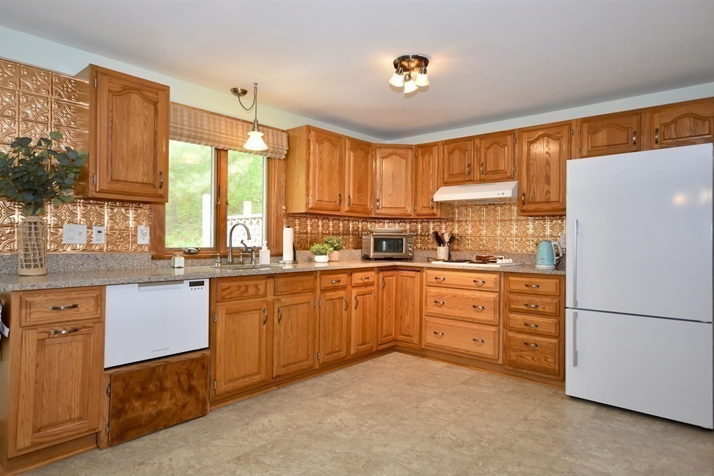 29 Tecumseh Road Bourne, MA 02562 - Photo 15 of 28 a kitchen with granite countertop stainless steel appliances a sink and a large window