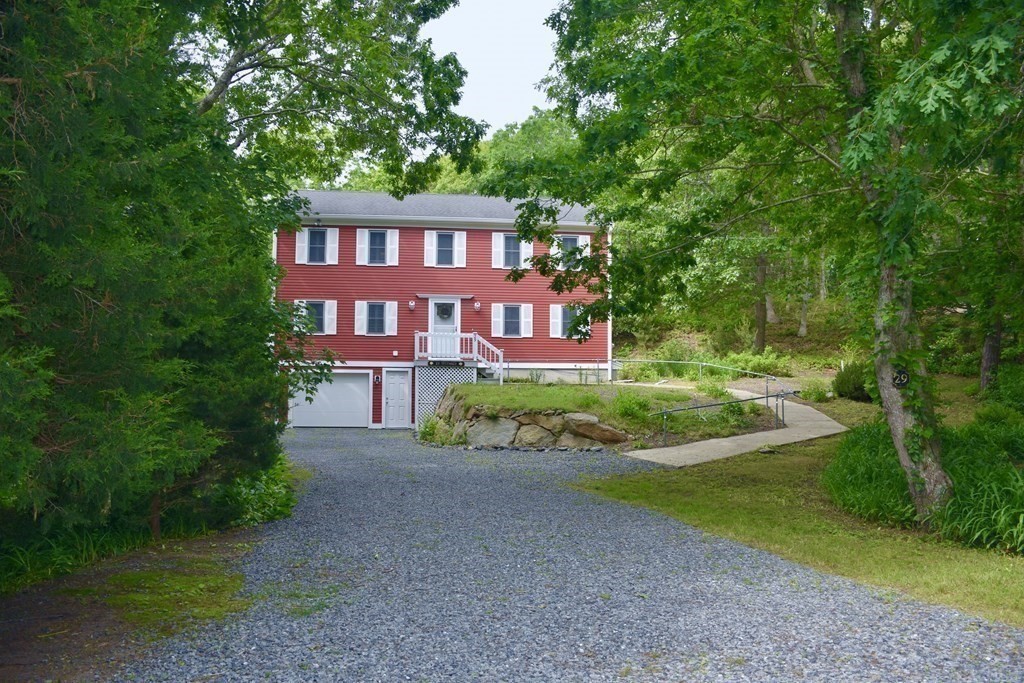 29 Tecumseh Road Bourne, MA 02562 - Photo 2 of 28 a view of a brick house next to a yard with big trees
