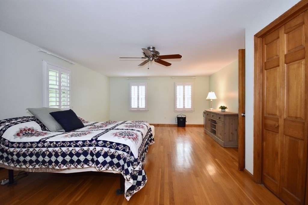 29 Tecumseh Road Bourne, MA 02562 - Photo 24 of 28 a bedroom with a bed and a chandelier