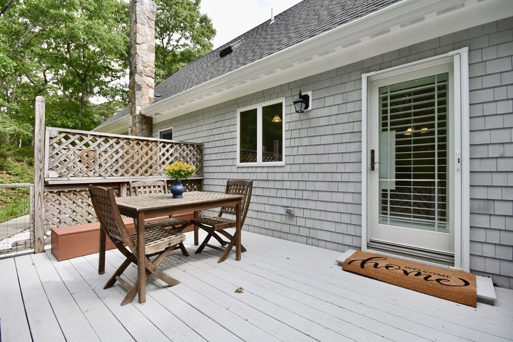 29 Tecumseh Road Bourne, MA 02562 - Photo 8 of 28 a patio of a house with table and chairs